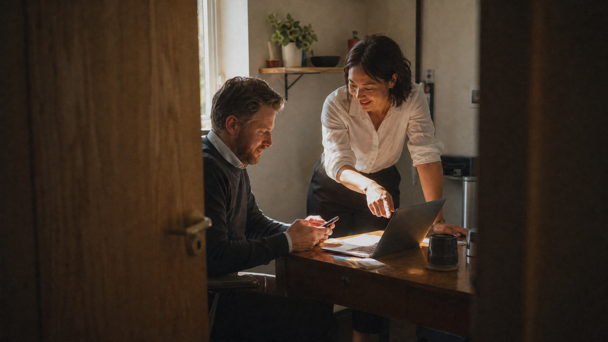 two restaurant managers in a small office sharing a moment of insight as they review numbers together